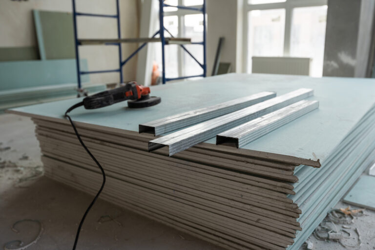 Working process of installing metal frames for plasterboard -drywall - for making gypsum walls in apartment is under construction, remodeling, renovation, extension, restoration and reconstruction. High quality photo